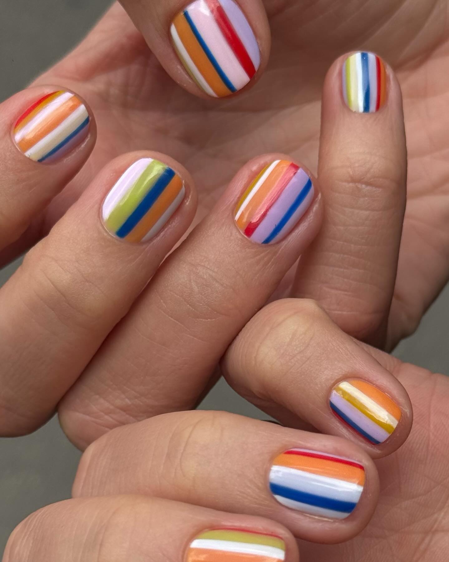 Colorful vertically striped nails.