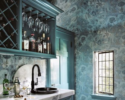 A wet bar furnished with paint and wallpaper
