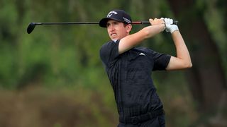 Tom McKibbin hits a fairway wood shot