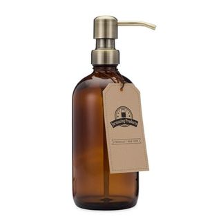 Amber glass hand soap pump bottle with a brass pump lid