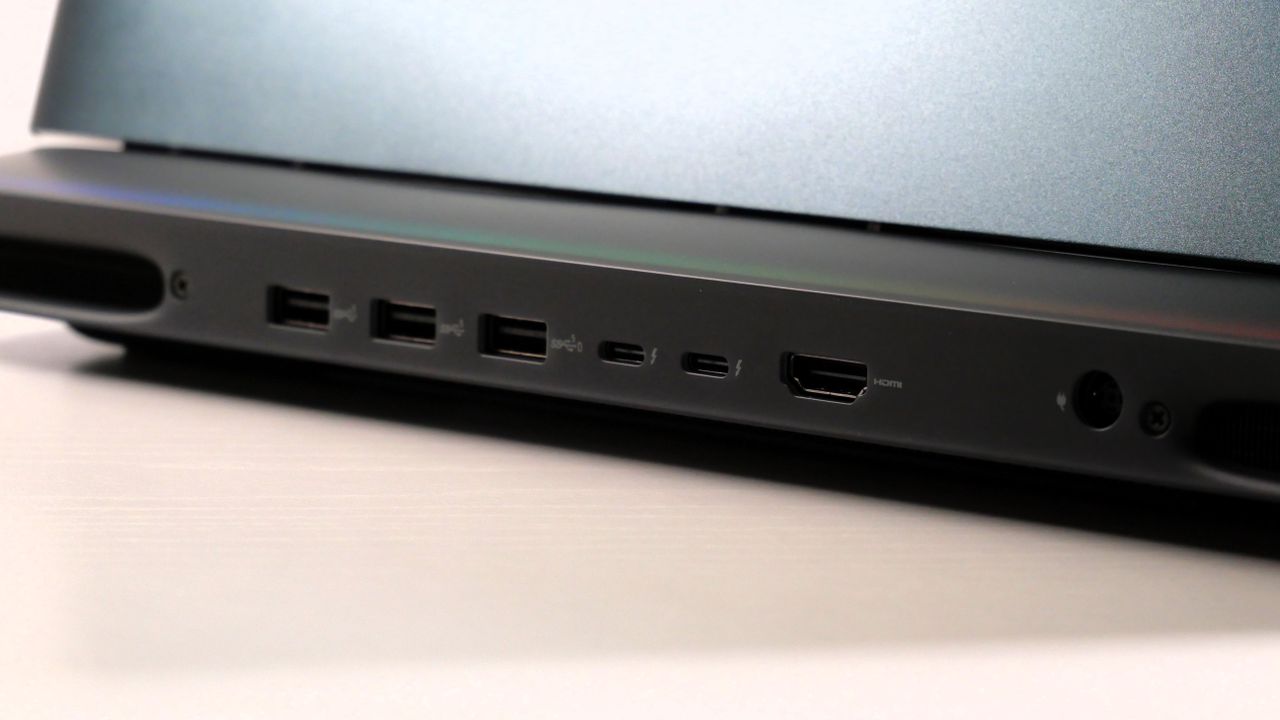 Alienware 16 Area-51 (RTX 5080) open on a white desk, highlighting the ports on the back.
