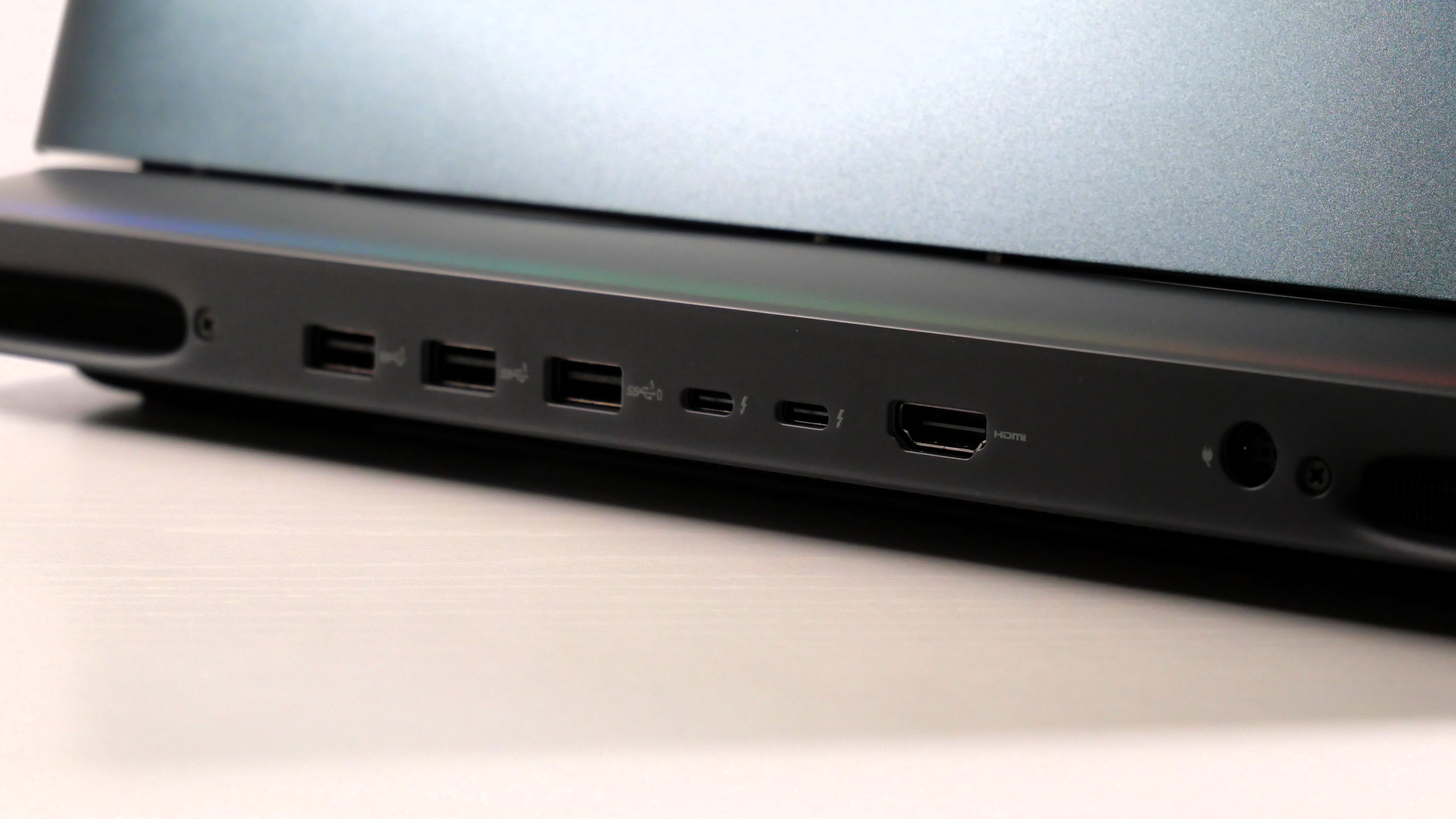 Alienware 16 Area-51 (RTX 5080) open on a white desk, highlighting the ports on the back.