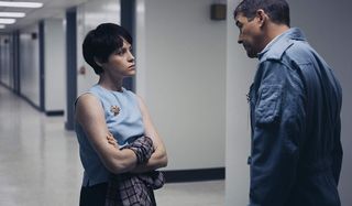 First Man Claire Foy glares at Kyle Chandler, arms crossed, in a hallway