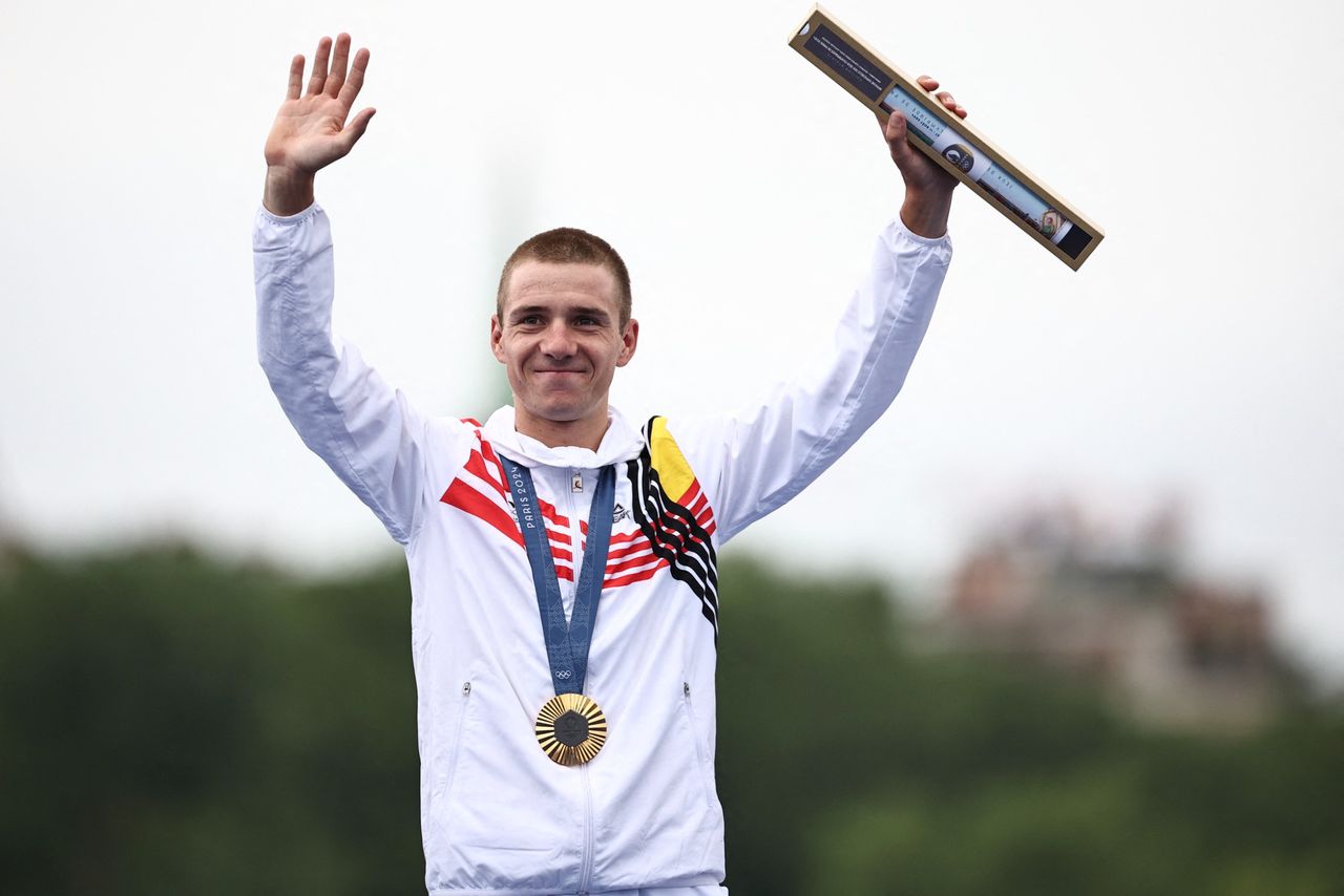 Gold medallist Belgium's Remco Evenepoel celebrates on the podium of the men's road cycling individual time trial during the Paris 2024 Olympic Games in Paris, on July 27, 2024. (Photo by Anne-Christine POUJOULAT / AFP) (Photo by ANNE-CHRISTINE POUJOULAT/AFP via Getty Images)