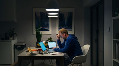 Man sitting at desk in dark