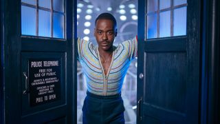 The Doctor (Ncuti Gatwa) poses opening the doors to the TARDIS for Doctor Who season 14