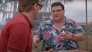Wayne Knight holding the Barbesol can while sitting at lunch`in Jurassic Park.