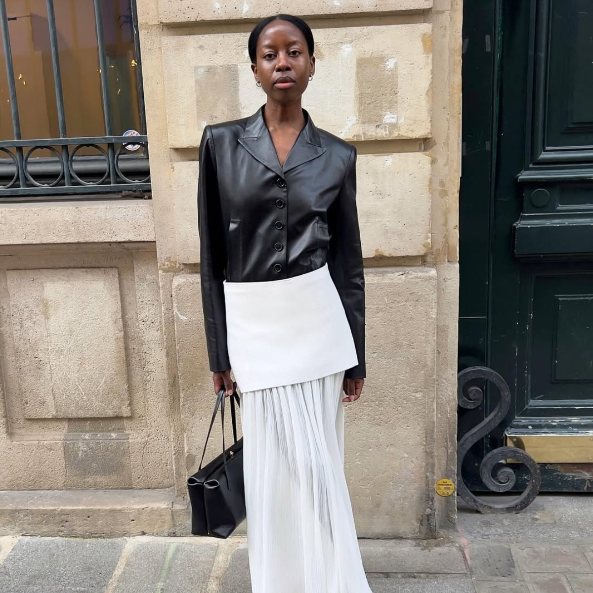 Sylvie in a white sheer skirt and black leather blazer