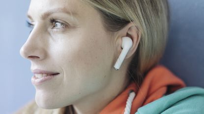 Woman listening to wireless earbuds
