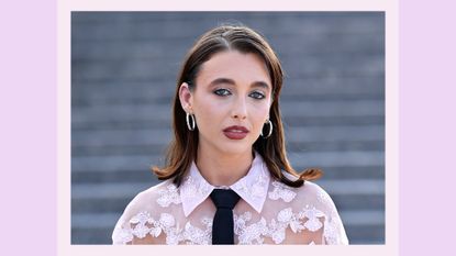 Emma Chamberlain pictured wearing a sheet pink floral top and sheer eyeshadow, with black eyeliner at the Valentino Haute Couture Fall/Winter 2023/2024 show as part of Paris Fashion Week at Chateau de Chantilly on July 05, 2023 in Chantilly, France/ in a purple template