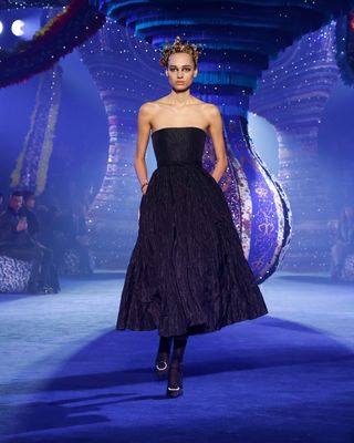 Woman on Dior runway in black dress