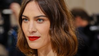 Alexa Chung wearing very subtle makeup with red lipstick