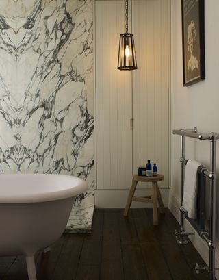 marble finish wall in a modern bathroom with freestanding bath