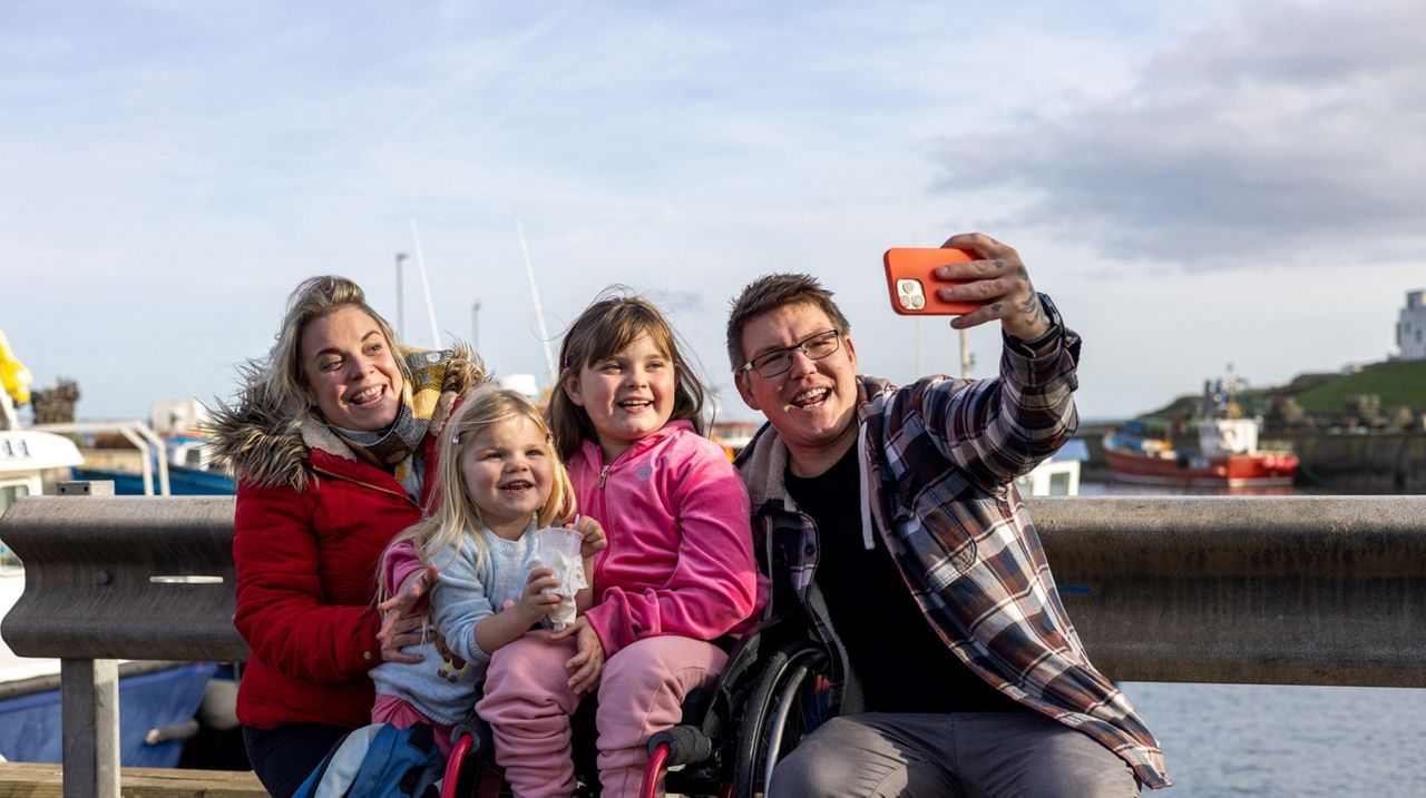 A family with two children taking a selfie.