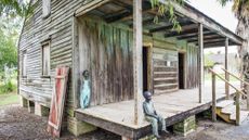 Sculptures of enslaved children outside of a slave cabin at Whitney Plantation