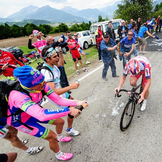 Filippo Pozzato gives his good friend, Luca Paolini, a prosecco shower during the Giro time trial above Lago di Garda.