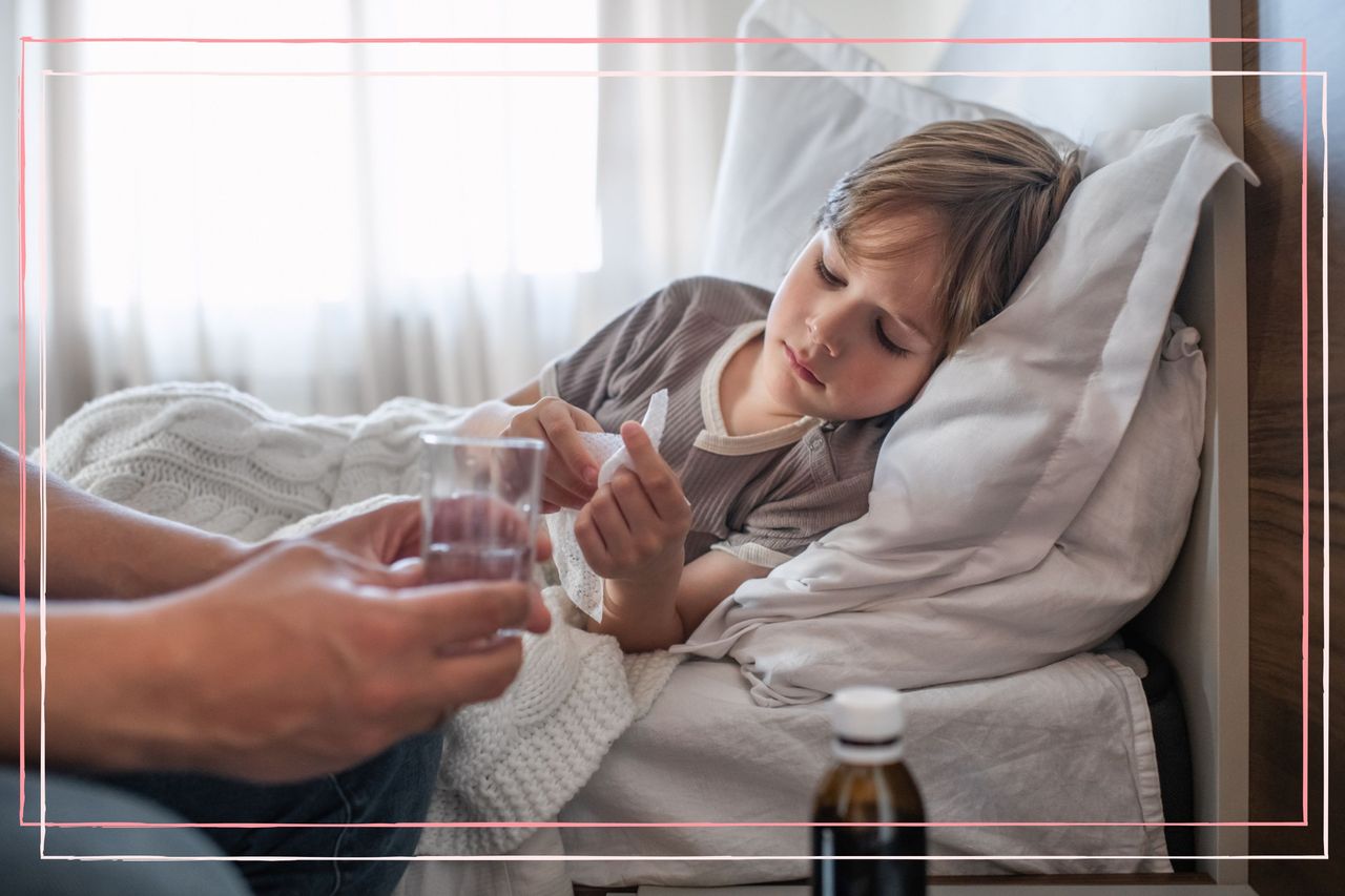 Little boy ill at home in bed with tonsillitis