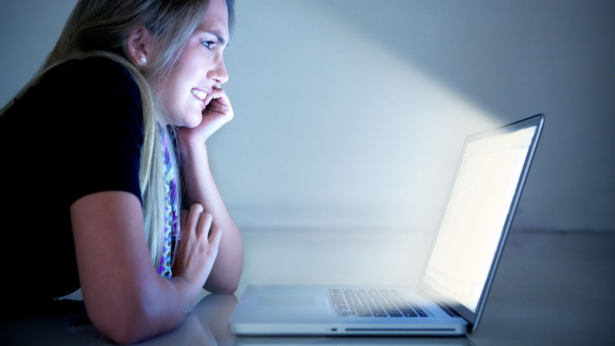 Woman grimacing at a bright computer screen