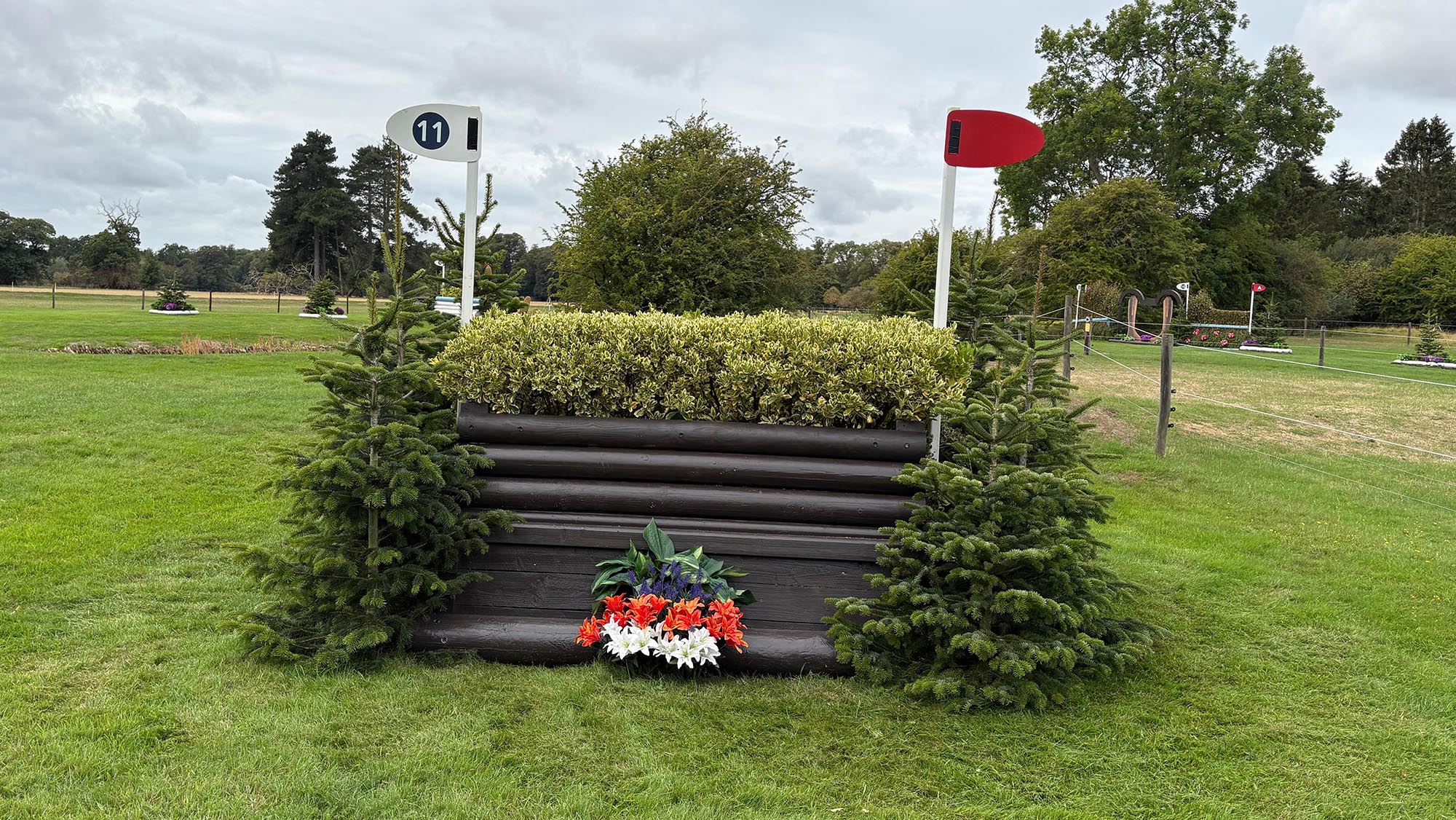 Narrow wooden fence topped with brush on Burghley cross-country course 2026