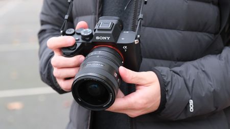 Sony A7 V camera held in a person's hands