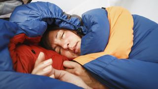 A woman sleeping in her sleeping bag