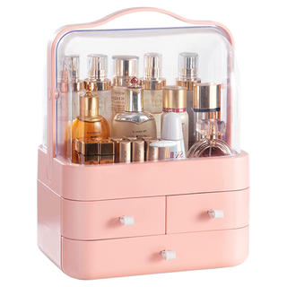 A pastel pink makeup organizer box with a clear top and handle