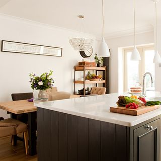 kitchen with wooden dining table and chopping board