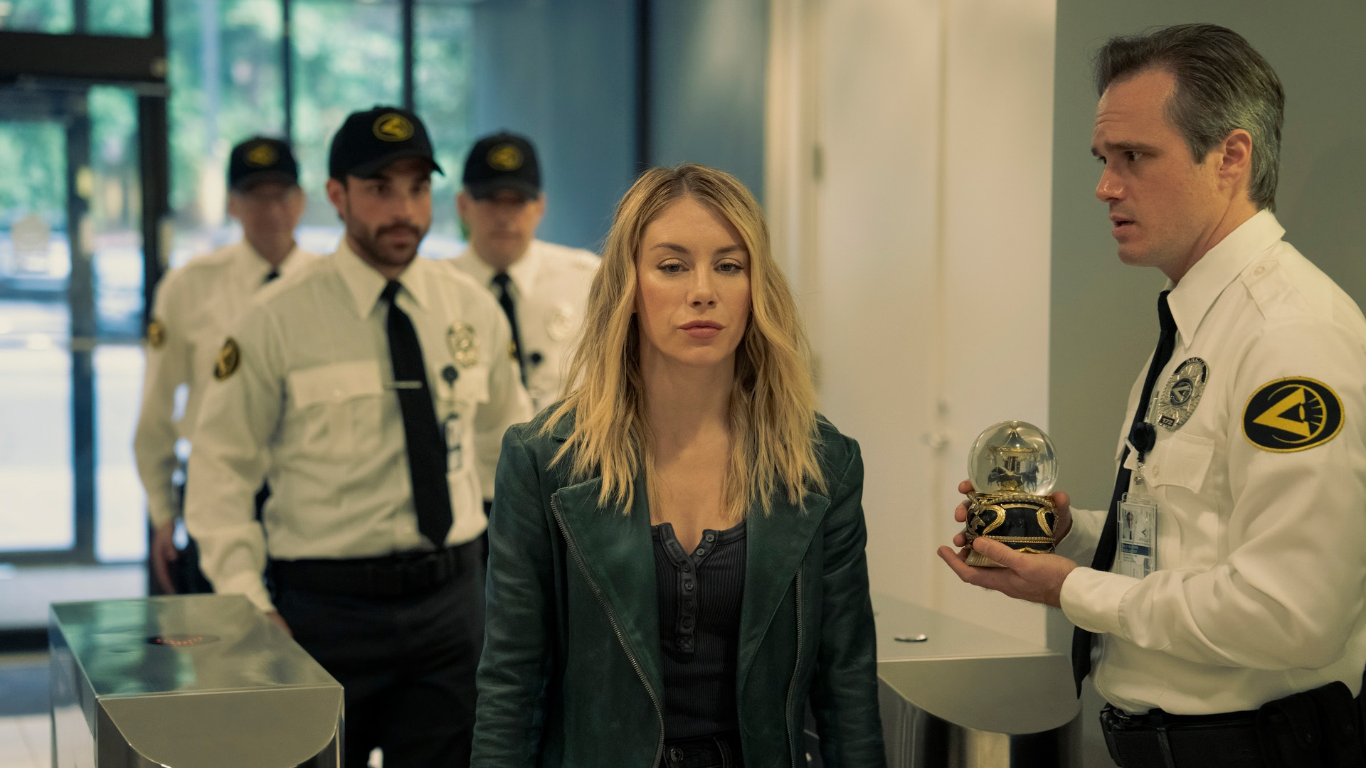 Harcourt (Jennifer Holland) in A.R.G.U.S. surrounded by guards in Peacemaker season 2, episode 6.