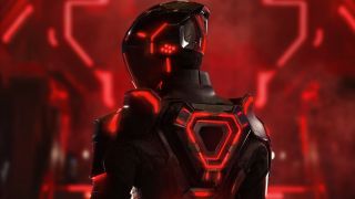 Screenshot from the movie Tron: Ares. A person is wearing a black bodysuit with red lights. Their face is covered with a black helmet, also with red lights.