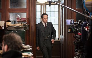 Behind the scenes shot of Hugh Grant in A Very English Scandal