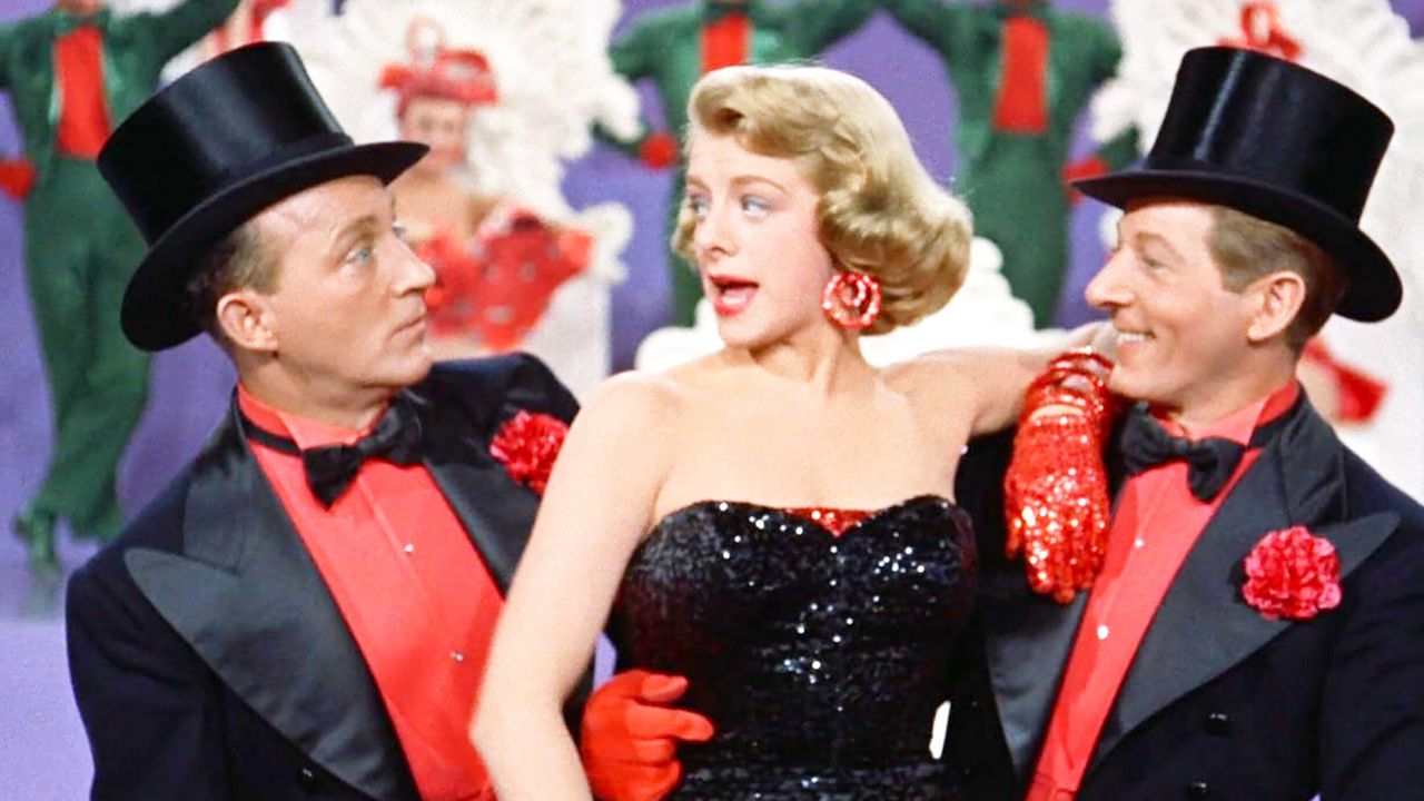 two men and a woman in red and black outfits singing in the movie white christmas