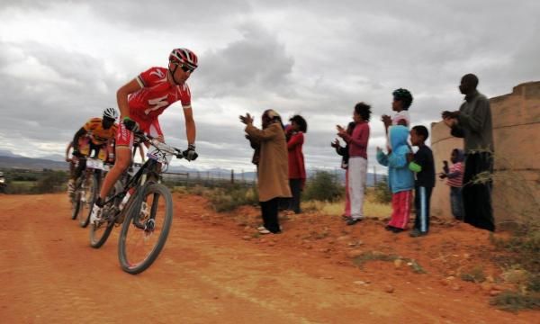 Christoph Sauser is cheered on by some locals.