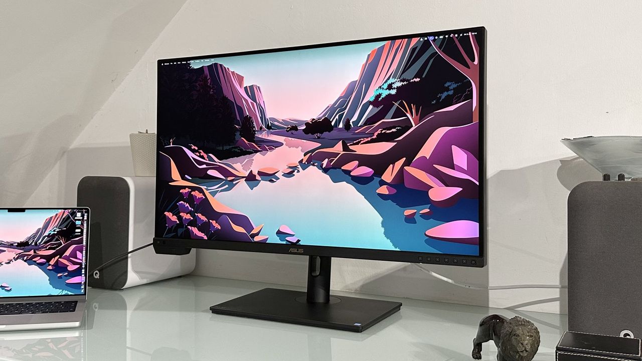 The Asus ProArt PA32KCX 8K monitor on a white desk in a home office during our review process