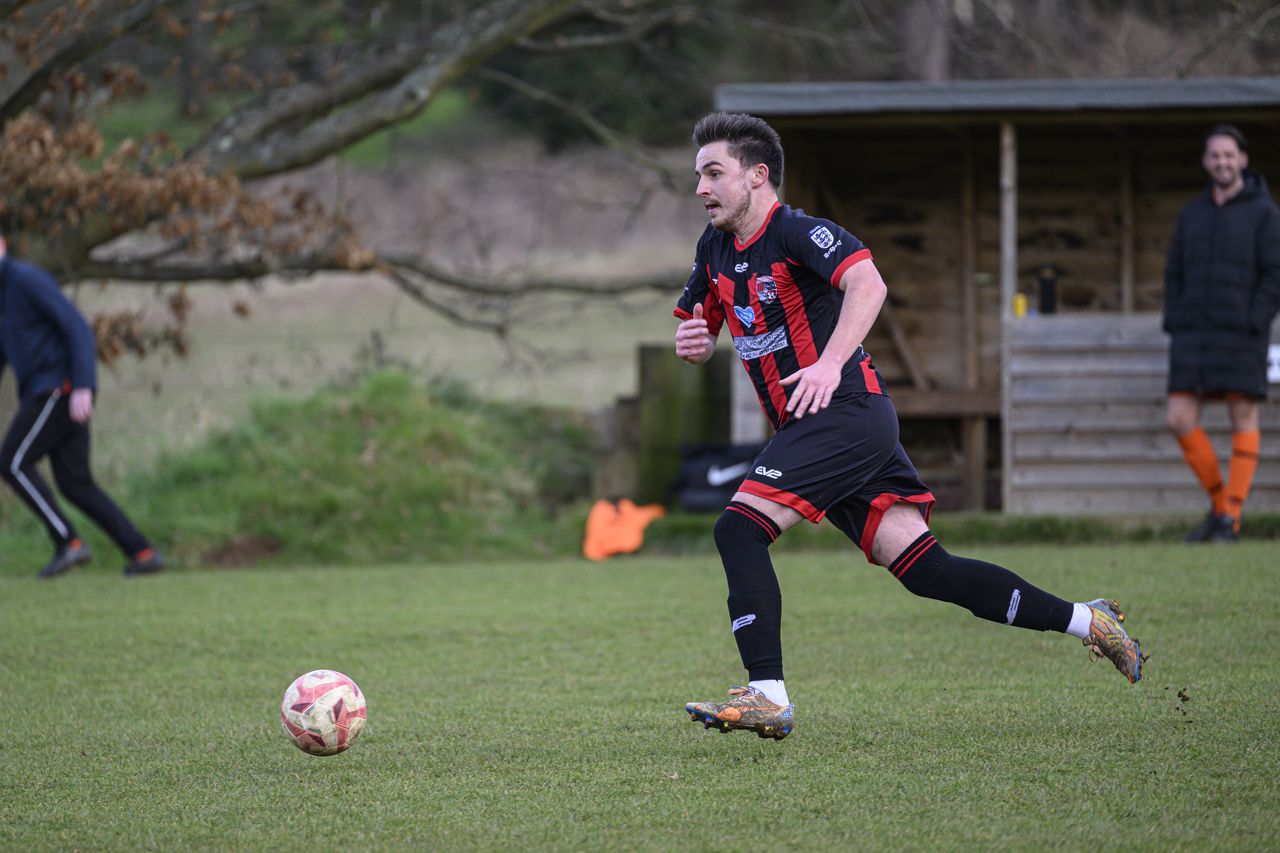 Some footballers playing in a field