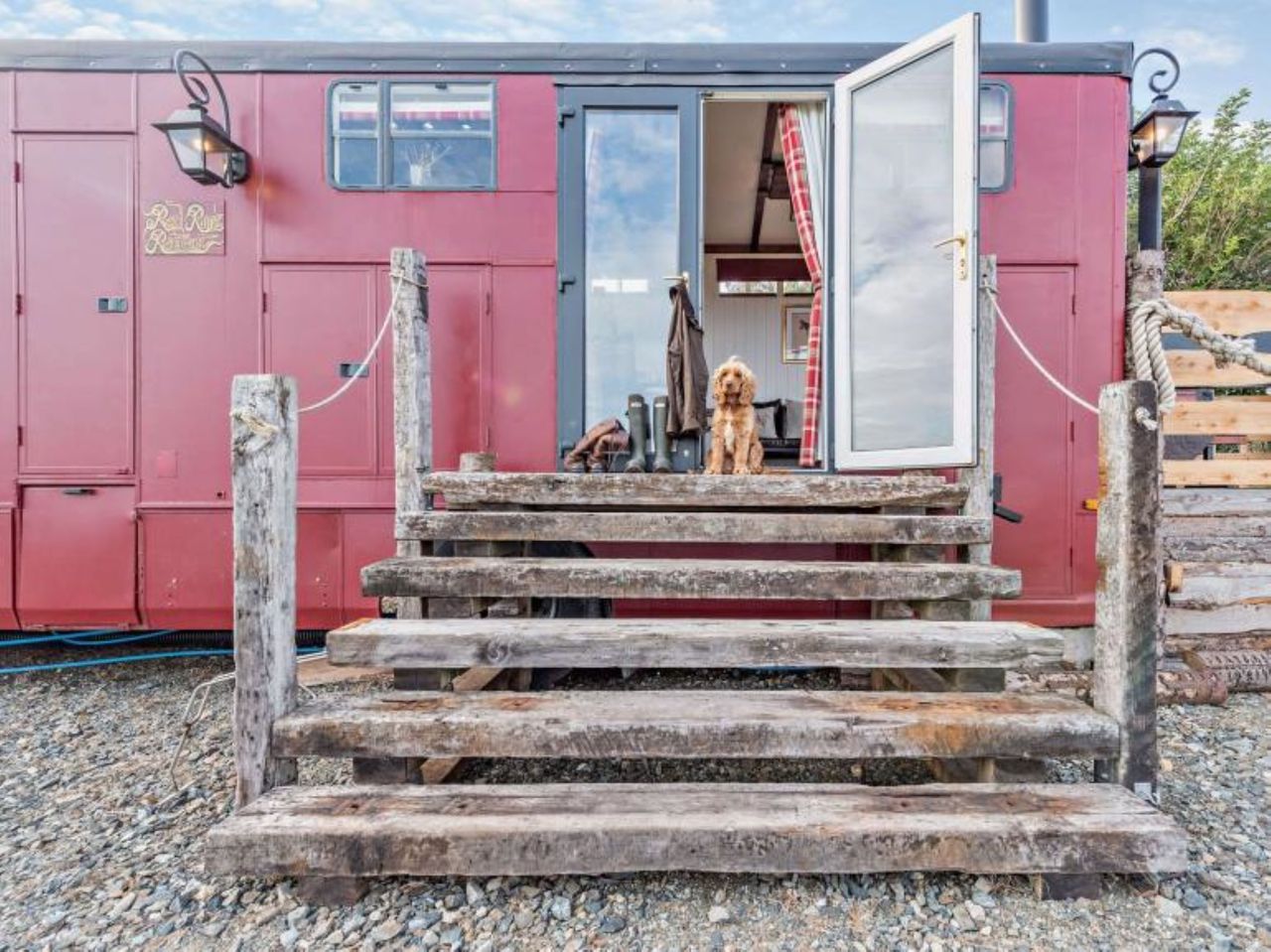 Wooden stairs lead to the entrance of the caravan
