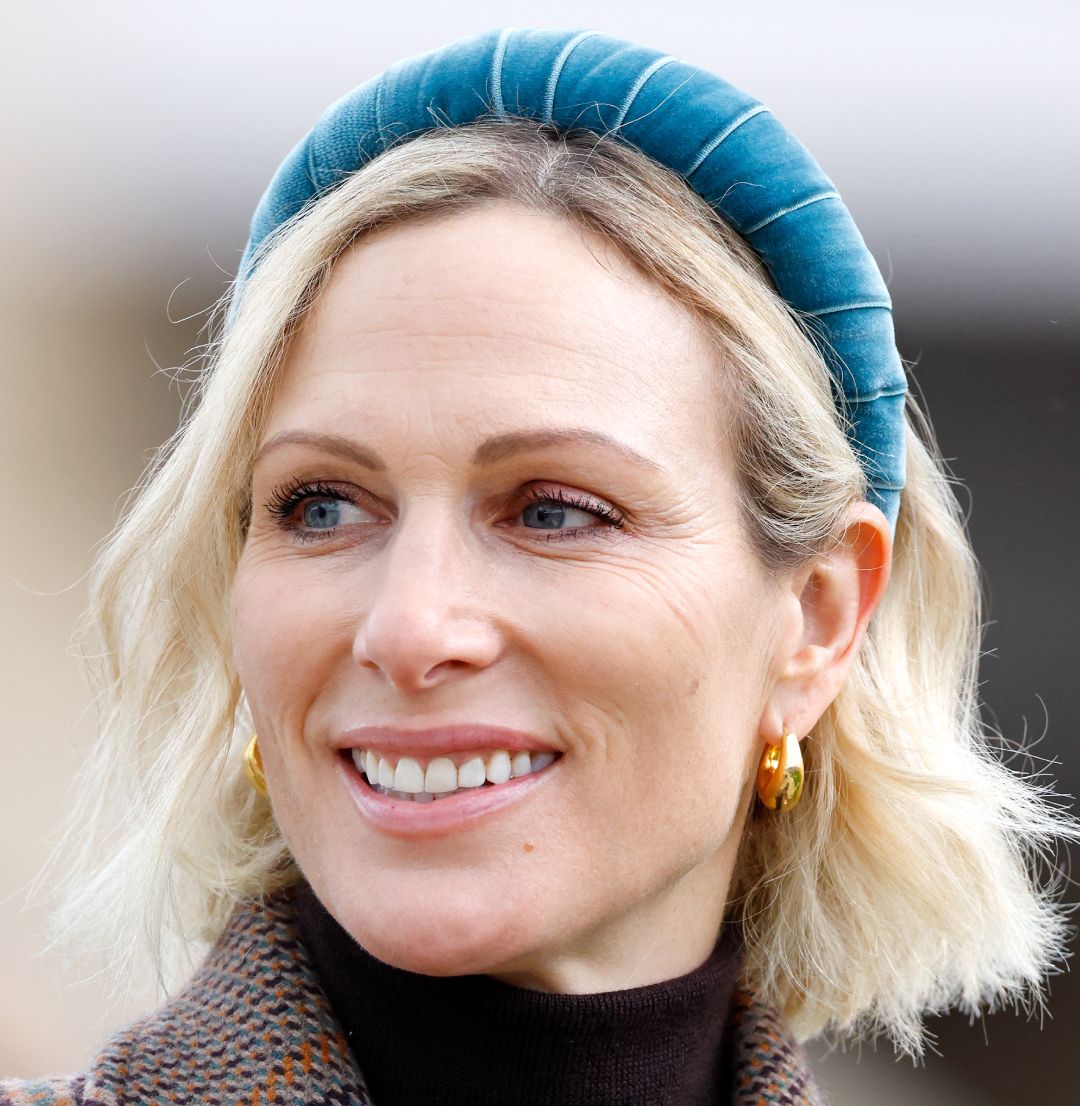 Zara Tindall wearing a blue headband and brown coat
