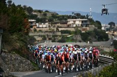 Team Ineos' British rider Geraint Thomas leads the pack along the sea during the Milan - Sanremo one-day classic cycling race, on March 22, 2025. (Photo by Marco BERTORELLO / AFP)