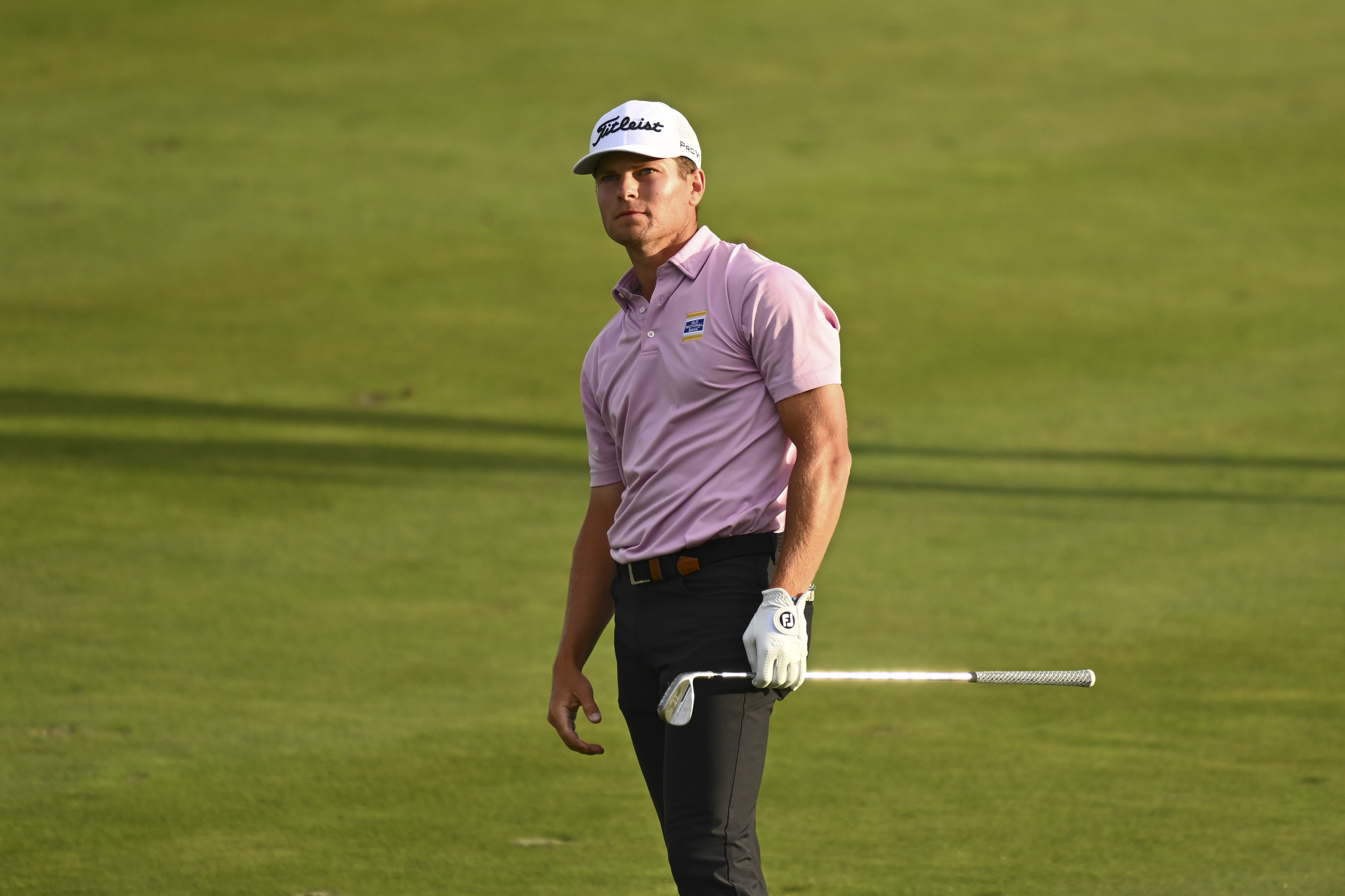 Michael Brennan hits a wedge shot and watches it in the air
