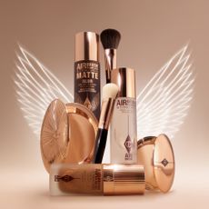 Best selling Charlotte Tilbury beauty products infront of an outline of angel wings