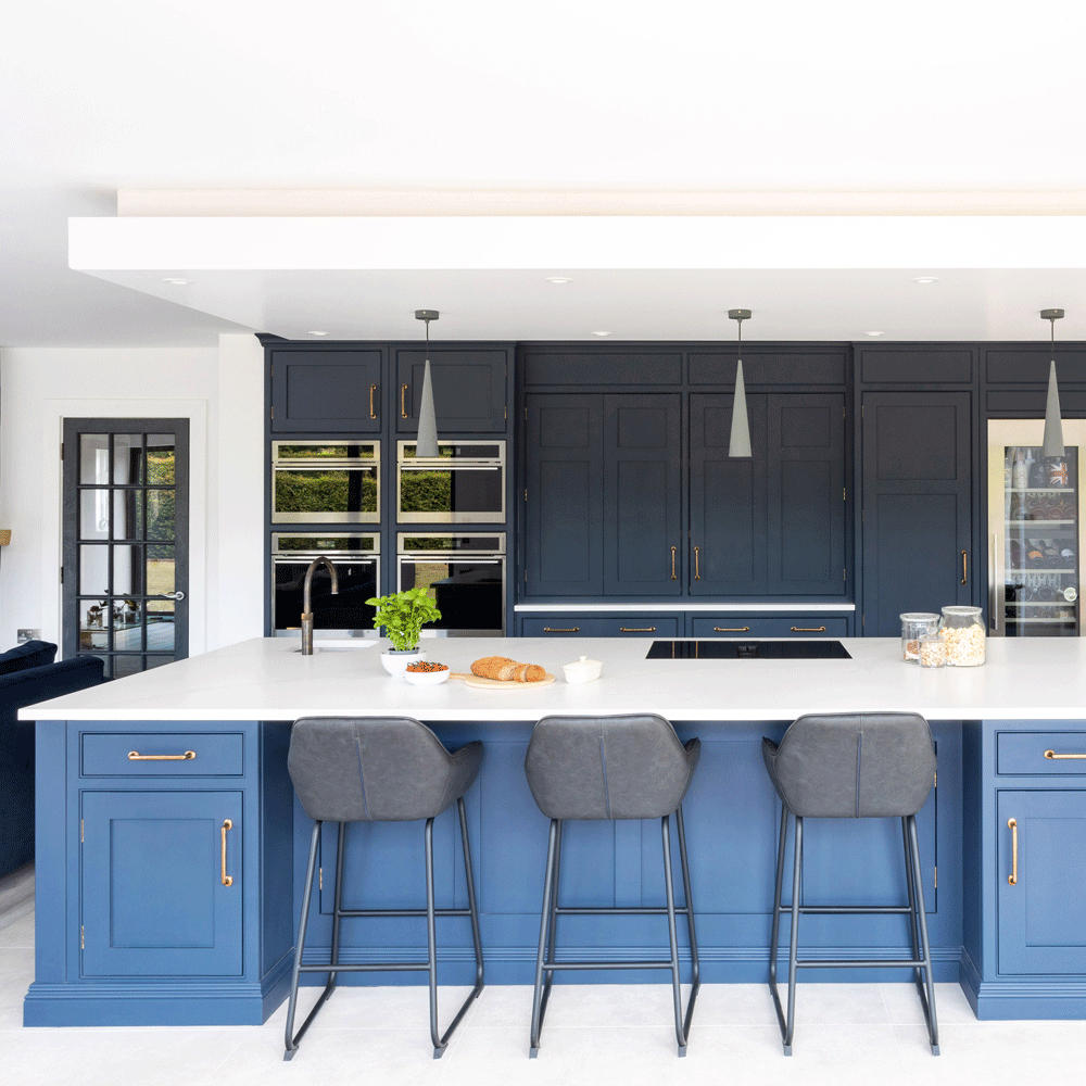 kitchen area with blue kitchen units and blue counter with white countertop