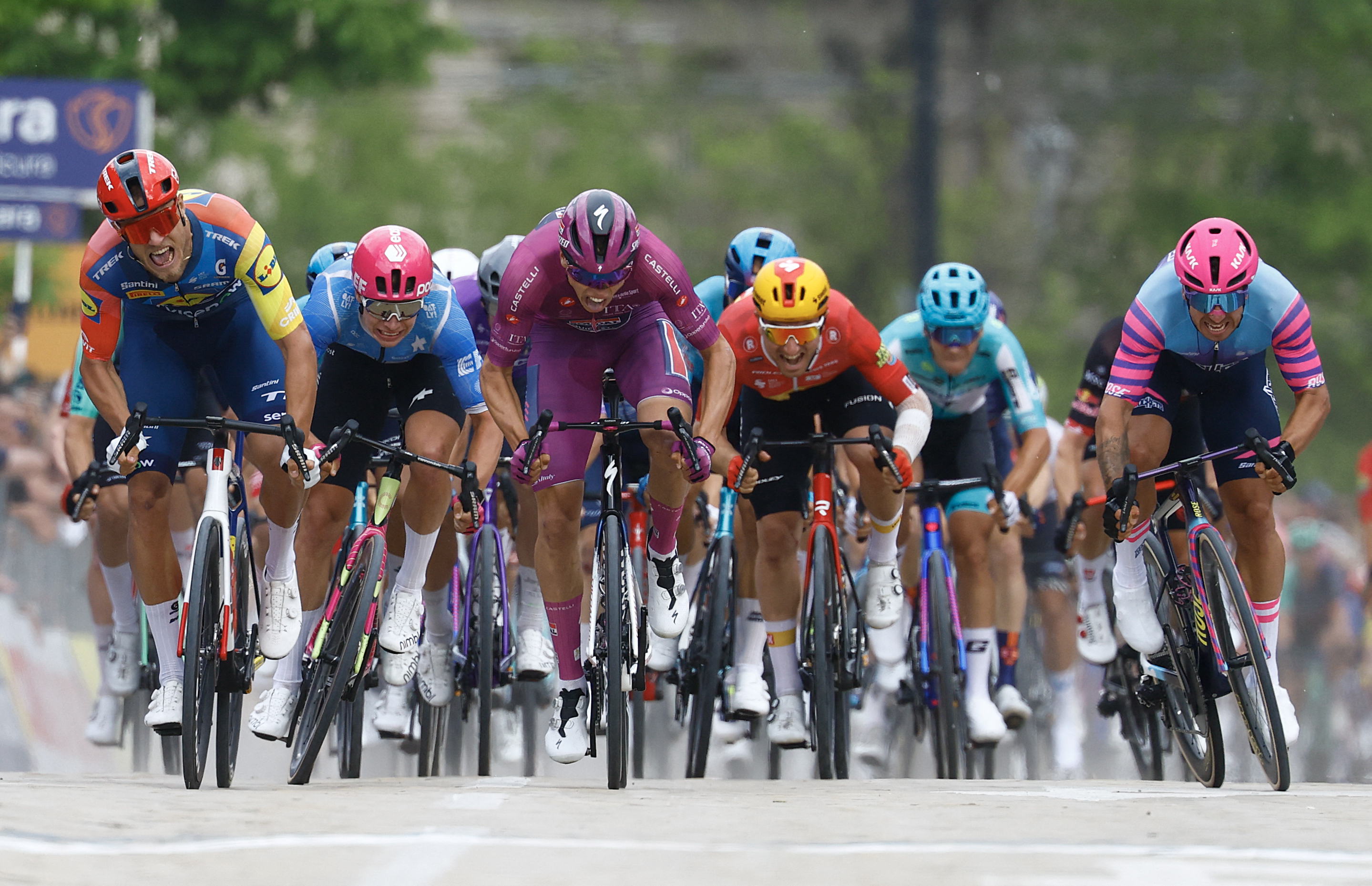 Soudal Quick-Step French rider Paul Magnier (C) wearing the points classification mauve jersey (Maglia Ciclamino) sprint to win next to Lidl - Trek Italian rider Jonathan Milan (L) in the 3nd stage of the Giro d'Italia 2026 - Tour of Italy cycling race between Plovdiv and Sofia, Bulgaria, on May 10, 2026. (Photo by Luca Bettini / AFP)