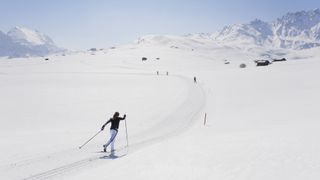 People skate skiing in the Italian Alps