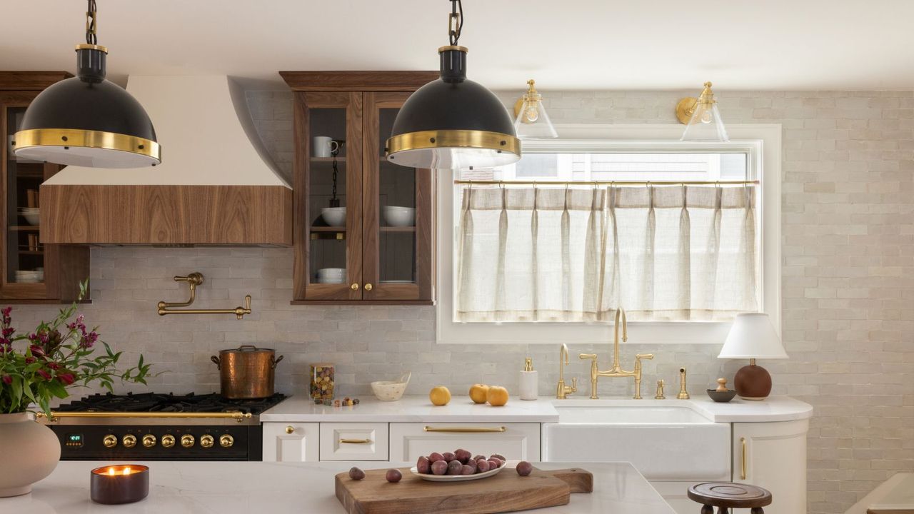 A neutral kitchen with white cabinets and cream zellige tiles on the the walls