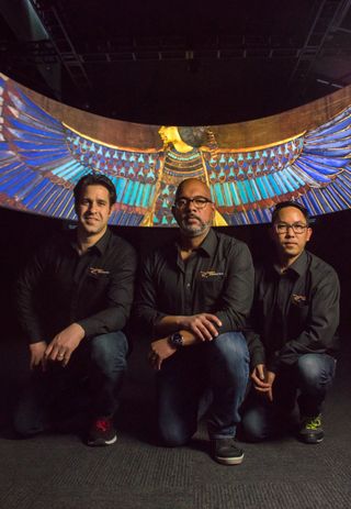 The main theater screen surrounds the Design Electronics team—Felice Taddeo, manager of technical services, Khalil Williams, general manager, and Scott Daeng, senior project engineer—which provided the AV supply and integration for the King Tut exhibits.