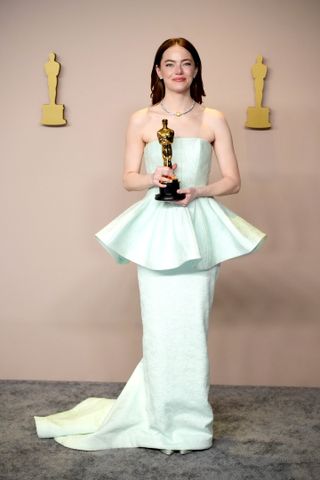 A photo of Emma Stone wearing a Louis Vuitton strapless icy blue gown at the 2024 Oscars.