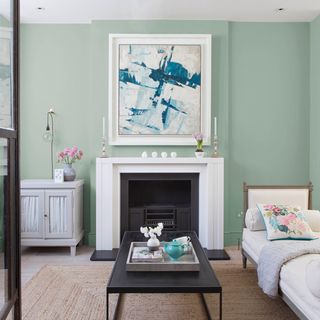 room with chalk paint green wall and wooden flooring
