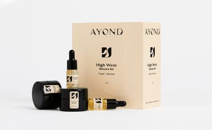 Ayond skincare set showing product box with day cream &amp; cleansing balm in black tubs and face oil and serum in dropper bottles