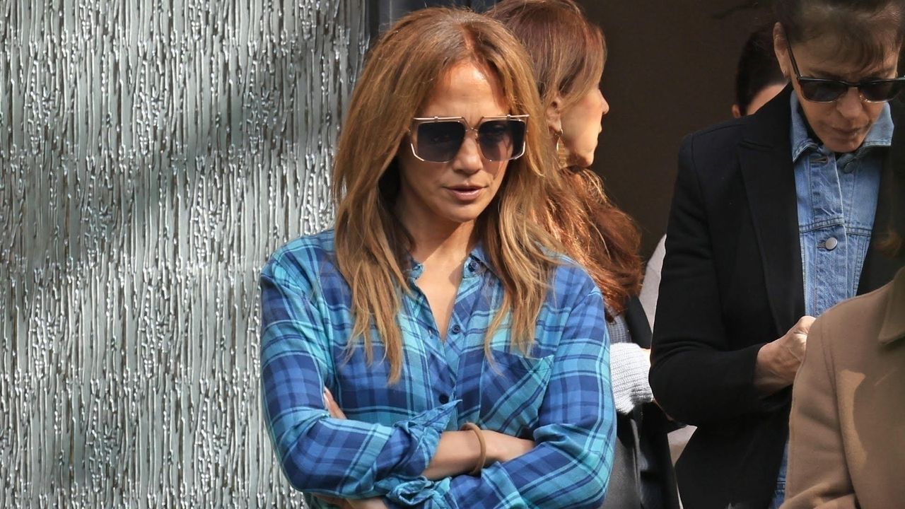 Jennifer Lopez leaves a real estate showing wearing a blue and turquoise flannel with ugg boots and ripped jeans