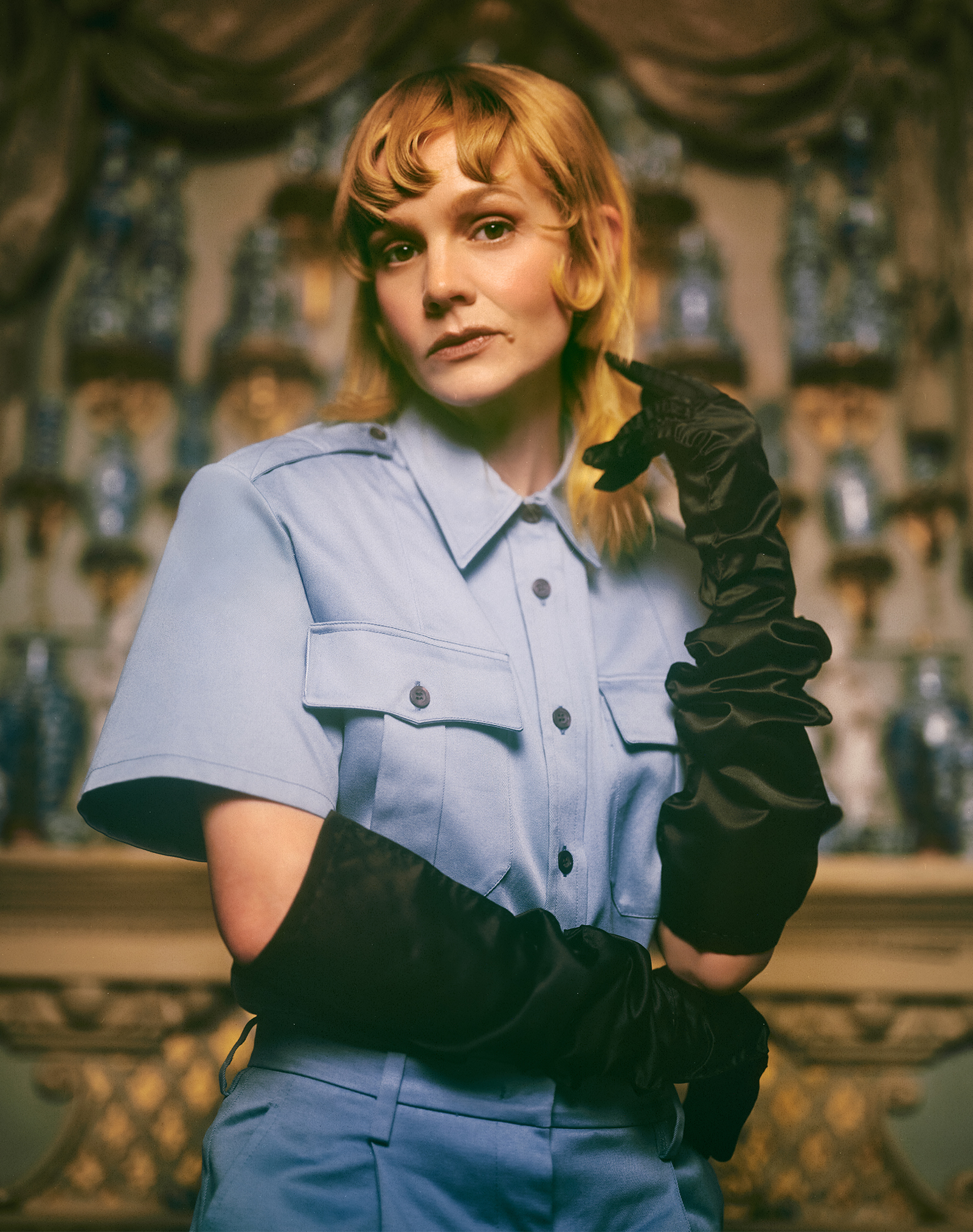 Carey Mulligan for Who What Wear's April cover story wearing a blue jumpsuit with black opera gloves.