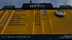 Looking up at the big yellow Open scoreboard